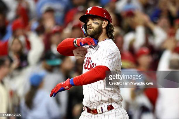 Bryce Harper of the Philadelphia Phillies celebrates after hitting a solo home run against Brad Hand of the Atlanta Braves during the fifth inning in...