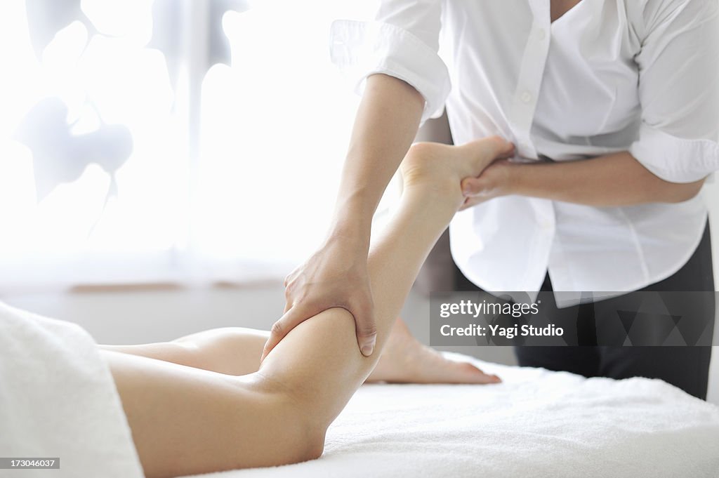 Woman receiving oil massage and relaxing