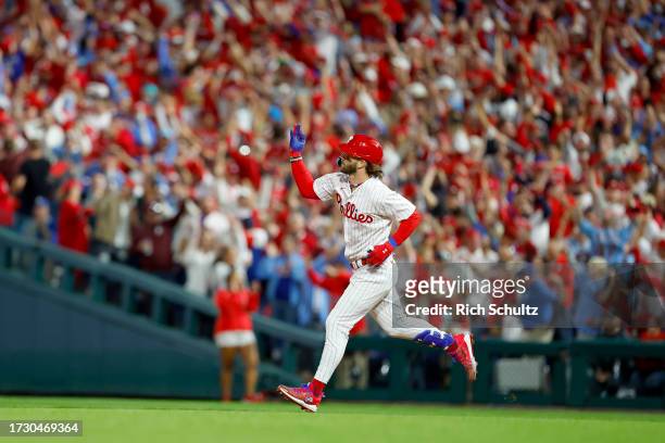 Bryce Harper of the Philadelphia Phillies rounds the bases after hitting a solo home run against Brad Hand of the Atlanta Braves during the fifth...