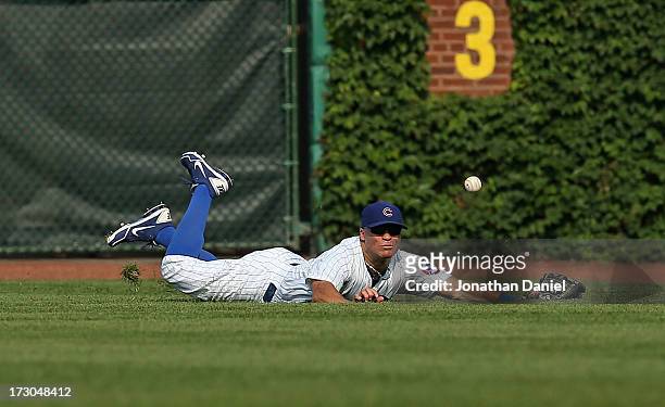 Scott Hairston of the Chicago Cubs dives in vain for a ball hit by Jose Tabata of the Pittsburgh Pirates in the 7th inning at Wrigley Field on July...