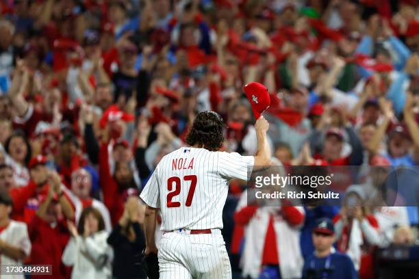 Aaron Nola of the Philadelphia Phillies tips his cap to the crowd as he walks back to the dugout after being relieved against the Atlanta Braves...