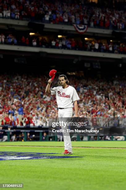 Aaron Nola of the Philadelphia Phillies tips his cap to the crowd as he walks back to the dugout after being relieved against the Atlanta Braves...