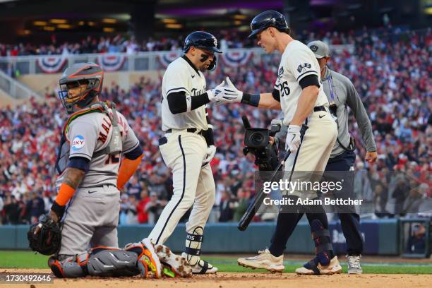 Royce Lewis of the Minnesota Twins celebrates his home run against the Houston Astros with Max Kepler during the first inning in Game Four of the...