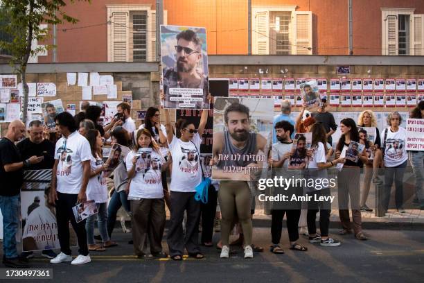 TEl AVIV, ISRAEL People hold signs with photos of hostages kidnapped and taken to Gaza in last Saturday's Hamas attack on October 17, 2023 in Tel...