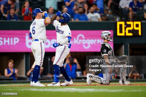 Adolis Garcia celebrates with Josh Jung of the Texas Rangers after hitting a home run during a game against the Chicago White Sox at Globe Life Field...