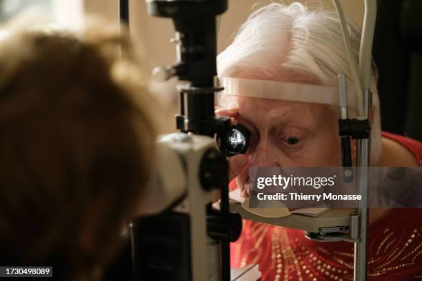 An elderly woman undergoes an ophthalmological examination on October 17, 2023 in Brussels, Belgium. 20 years after cataract surgery, where her...