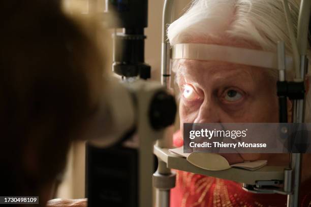 An elderly woman undergoes an ophthalmological examination, on October 17, 2023 in Brussels, Belgium. 20 years after cataract surgery, where her...