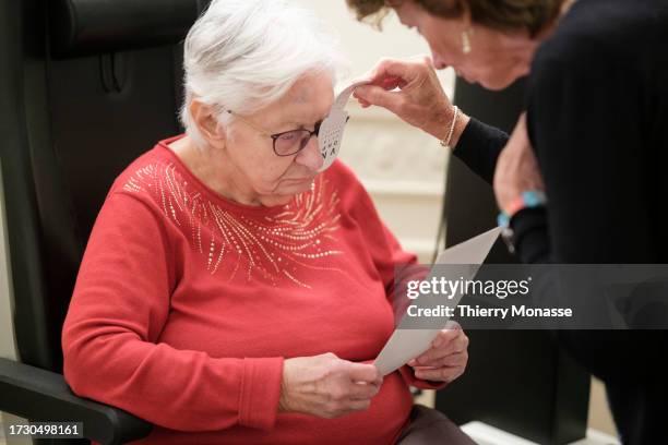 An elderly woman undergoes an ophthalmological examination, on October 17, 2023 in Brussels, Belgium. 20 years after cataract surgery, where her...