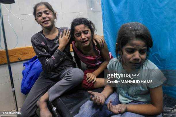 Graphic content / TOPSHOT - Palestinian children injured in an Israeli air strike await treatment at the Nasser hospital in Khan Yunis in the...