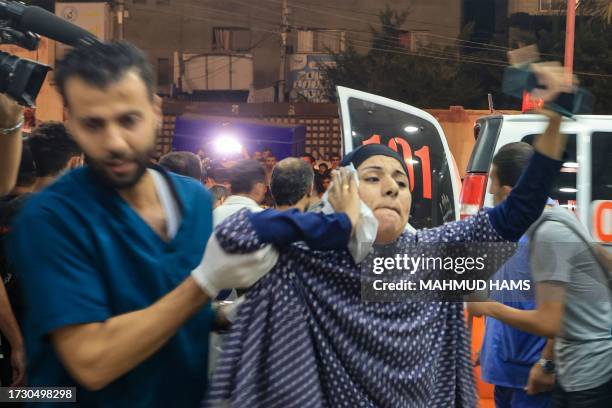 Graphic content / A Palestinian woman injured in an Israeli air strike reacts as she is taken for treatment at the Nasser hospital in Khan Yunis in...