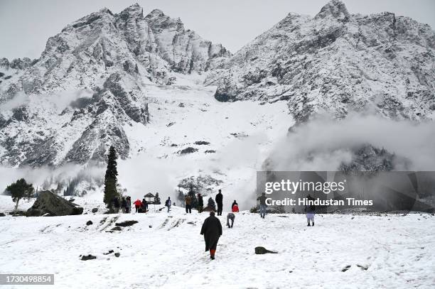 Tourists are seen enjoying after season's first snowfall on October 17, 2023 in Sonamarg, India.