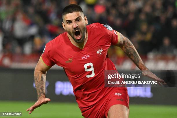 Serbia's forward Aleksandar Mitrovic celebrates after scoring the first team goal during the UEFA Euro 2024 Group G qualifying football match between...