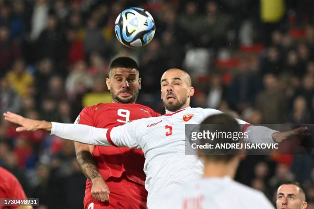 Serbia's forward Aleksandar Mitrovic fights for the ball with Montenegro's defender Marko Tuci during the UEFA Euro 2024 Group G qualifying football...