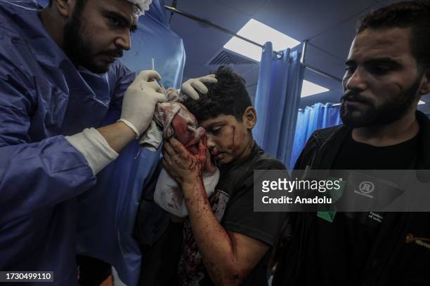 Injured Palestinian boy taken to Al-Shifa Hospital following an explosion at Al-Ahli Baptist Hospital in Gaza City, Gaza on October 17, 2023. Over...