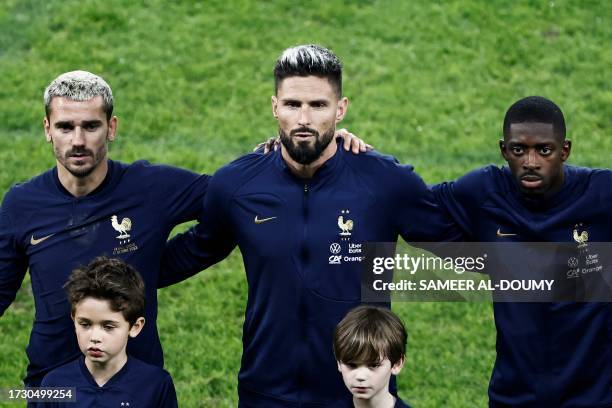 France's forward Antoine Griezmann, France's forward Olivier Giroud and France's forward Ousmane Dembele sing the French national anthem ahead of the...