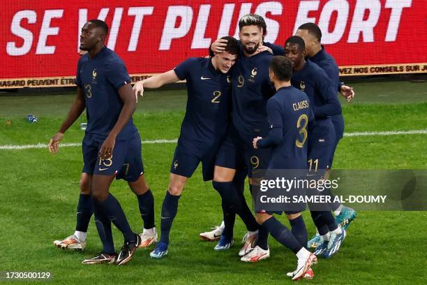 France's defender Benjamin Pavard celebrates with teammates after scoring his team's first goal during the friendly football match between France and...