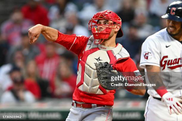 Luke Maile of the Cincinnati Reds throws to third base during the third inning against the Cleveland Guardians at Progressive Field on September 26,...