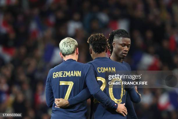 France's forward Kingsley Coman celebrates after scoring his team's fourth goal with France's forward Antoine Griezmann during the friendly football...