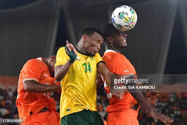 South Africa's Mothobi Mvala fights for the ball with Ivory Coast's 22 Haller Sebastien and Ivory Coast's Evan Ndicka during the international...