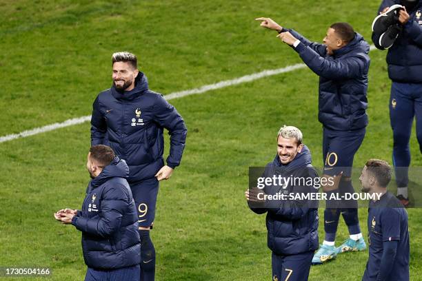 France's forward Olivier Giroud , France's forward Antoine Griezmann , France's forward Kylian Mbappe and France's defender Jonathan Clauss celebrate...