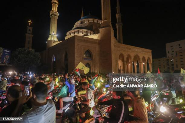 Lebanese protesters wave Palestinian national flags and shout slogans in solidarity with the people of Gaza in down town Beirut, after a strike on a...