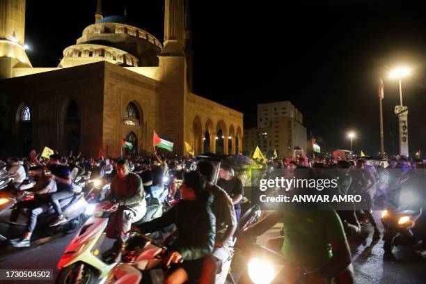 Lebanese protesters wave Palestinian national flags and shout slogans in solidarity with the people of Gaza in down town Beirut, after a strike on a...