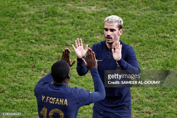 France's forward Antoine Griezmann is substitued by France's midfielder Youssouf Fofana during the friendly football match between France and...