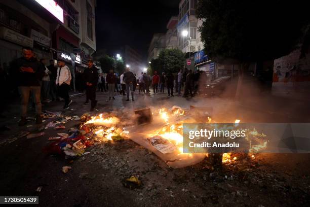 People gather to protest after a blast at Al-Ahli Baptist Hospital in Gaza as Israeli attacks continue, in Ramallah, West Bank on October 17, 2023....