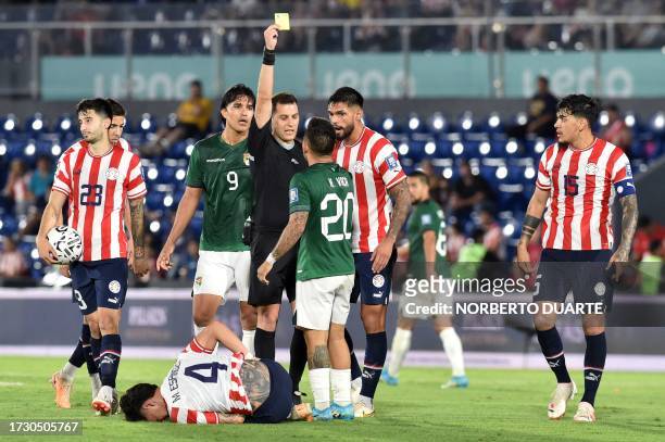Uruguayan referee Gustavo Tejera shows the yellow card to Bolivia's midfielder Henry Vaca during the 2026 FIFA World Cup South American qualification...
