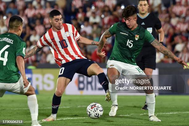 Paraguay's midfielder Miguel Almiron and Bolivia's midfielder Gabriel Villamil fight for the ball during the 2026 FIFA World Cup South American...