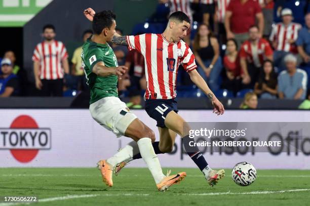 Paraguay's midfielder Miguel Almiron and Bolivia's defender Jose Sagredo fight for the ball during the 2026 FIFA World Cup South American...