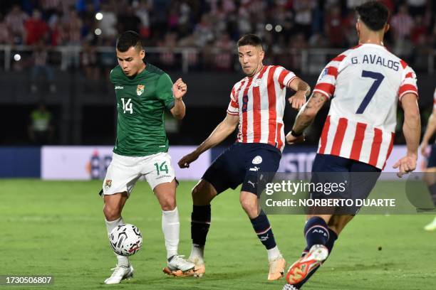 Bolivia's midfielder Moises Villarroel and Paraguay's midfielder Alvaro Campuzano fight for the ball during the 2026 FIFA World Cup South American...