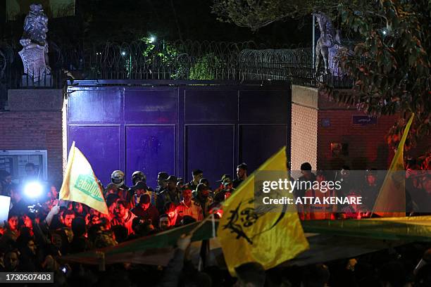 Iranian students and demonstrators protest in support of Palestinians in front of the British embassy in Tehran, early morning on October 18, 2023....