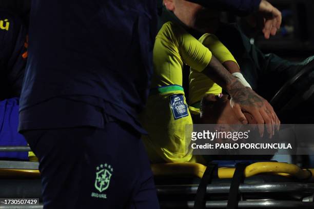 Brazil's forward Neymar leaves the field after an injury during the 2026 FIFA World Cup South American qualification football match between Uruguay...
