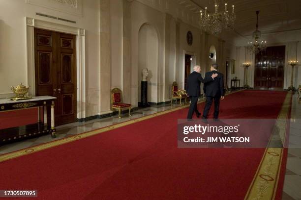 President Barack Obama and US Vice President Joe Biden walk together after delivering a statement to the nation following the vote in the House of...