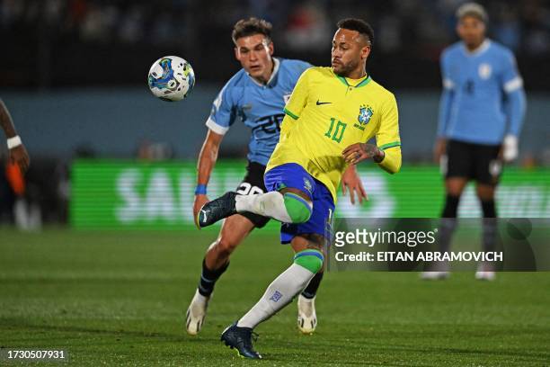 Brazil's forward Neymar and Uruguay's midfielder Manuel Ugarte fight for the ball during the 2026 FIFA World Cup South American qualification...