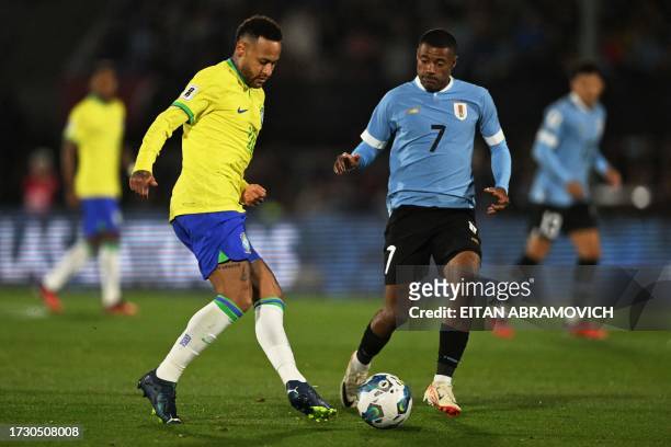 Brazil's forward Neymar and Uruguay's midfielder Nicolas De La Cruz fight for the ball during the 2026 FIFA World Cup South American qualification...