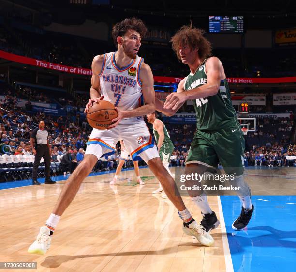 Chet Holmgren of the Oklahoma City Thunder looks to pass the ball during the game against the Milwaukee Bucks on October 17, 2023 at Paycom Center in...