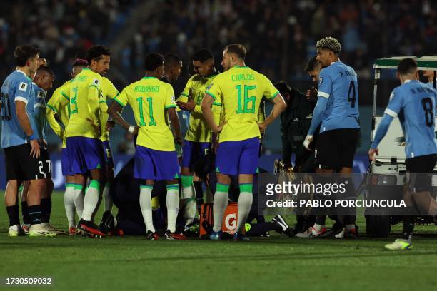 Brazilian players stand next to forward Neymar before he went off injured during the 2026 FIFA World Cup South American qualification football match...