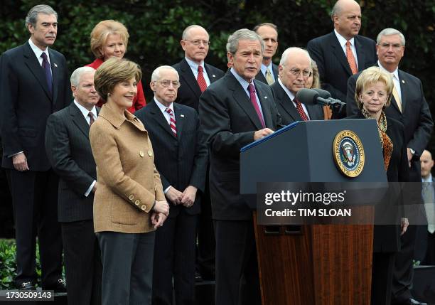 President George W. Bush and First Lady Laura Bush stand on stage with Bush cabinet members, US Vice President Dick Cheney and his wife Lynne as the...