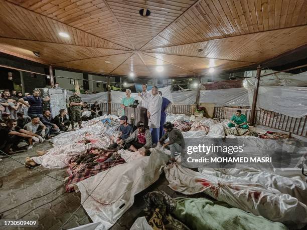 Gaza, Palastine. Amid the tragic aftermath of the bombing of Gaza's Al-Ahli Baptist Hospital on October 17 doctors at Al-Shifa Hospital gather to...