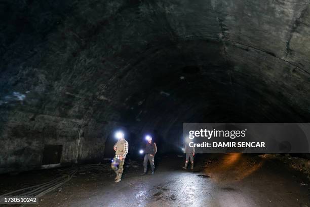 Visitors flashlights as they walk inside a dark tunnels at the Zeljava underground army airbase in the heart of the Pljesevica mountain, on Croatia's...