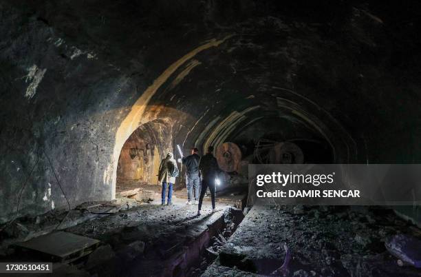 Visitors flashlights as they walk inside a dark tunnels at the Zeljava underground army airbase in the heart of the Pljesevica mountain, on Croatia's...