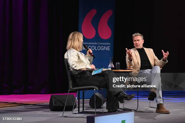 October 2023, North Rhine-Westphalia, Cologne: Moderator Anja Backhaus and author Dirk Steffens , l-r, reads at Lit.Cologne special, the...