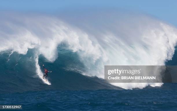 Hawaiian surfer Steve Roberson rides a wave as a big swell hits Pe'ahi surfing break, known as Jaws, on the north shore of the island of Maui, Hawaii...