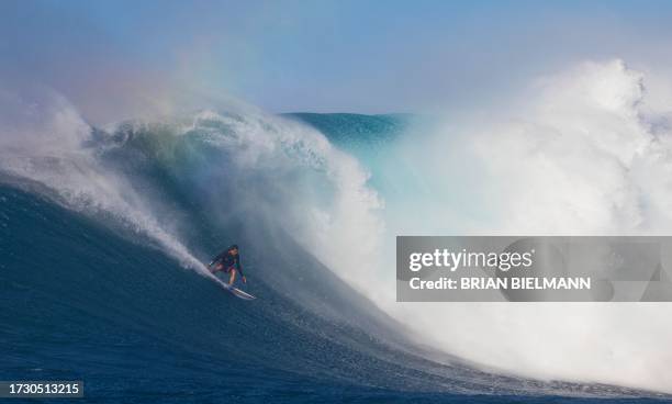 Surfer Kai Lenny rides a wave as a big swell hits Pe'ahi surfing break, known as Jaws, on the north shore of the island of Maui, Hawaii on October...