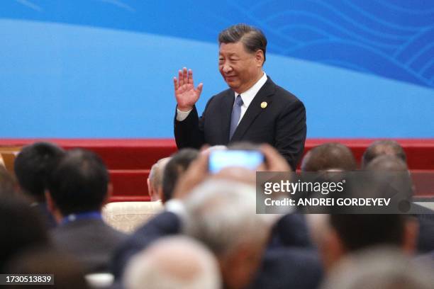 This pool photograph distributed by Russian state owned agency Sputnik shows Chinese President Xi Jinping gesturing during the opening ceremony of...