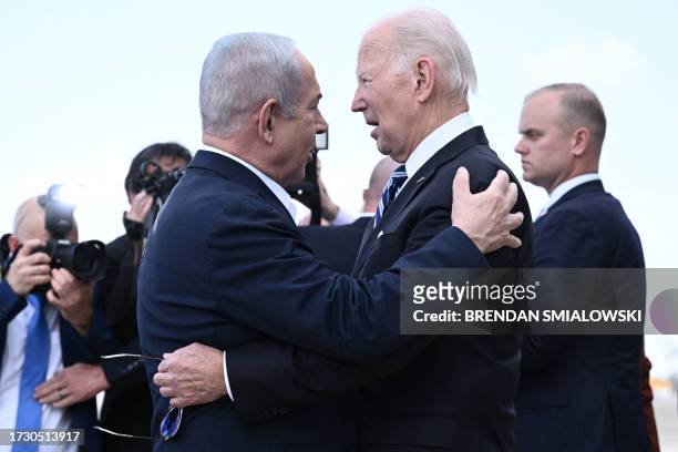 Israel Prime Minister Benjamin Netanyahu greets US President Joe Biden upon his arrival at Tel Aviv's Ben Gurion airport on October 18 amid the...