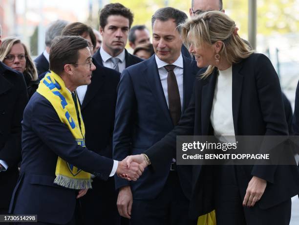 Swedish Prime Minister Ulf Kristersson shakes hands with Belgium Interior Minister Annelies Verlinden as they stand with Prime Minister Alexander De...