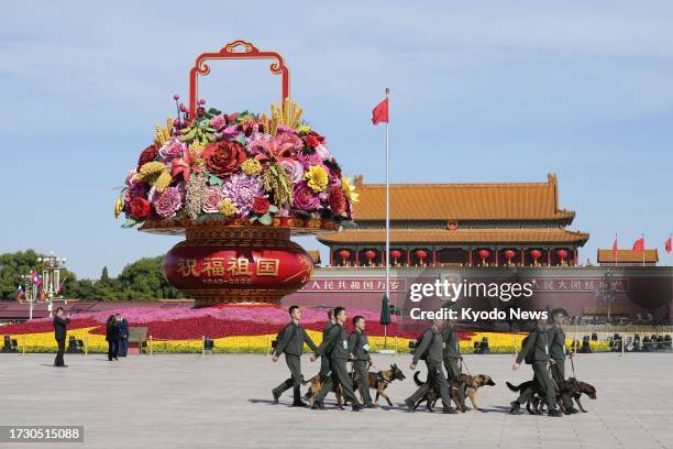 Security officers patrol at Tiananmen Square in Beijing on Oct. 18 as China hosts an international forum on its Belt and Road global infrastructure...